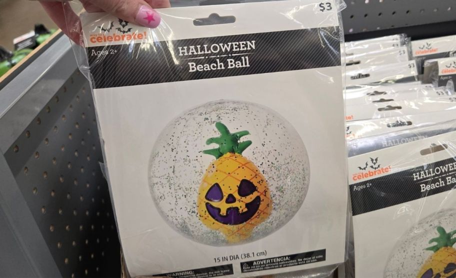 a woman's hand holding a pineapple summerween beachball