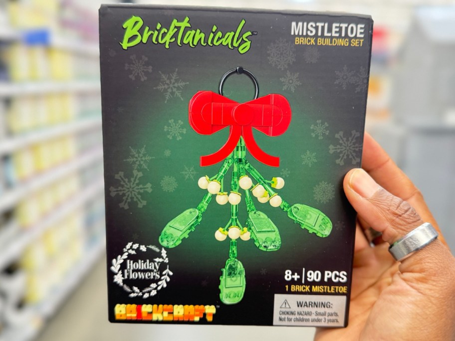 hand holding Brickcraft Bricktanicals Holiday Flowers Mistletoe Building Kit 90-Piece Set