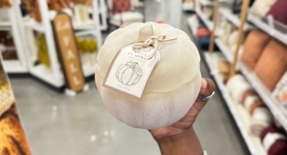 hand holding pumpkin candle at the store