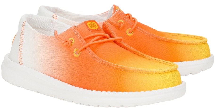 kid's HEYDUDE shoes meant to look like candy corn in orange, yellow, and white