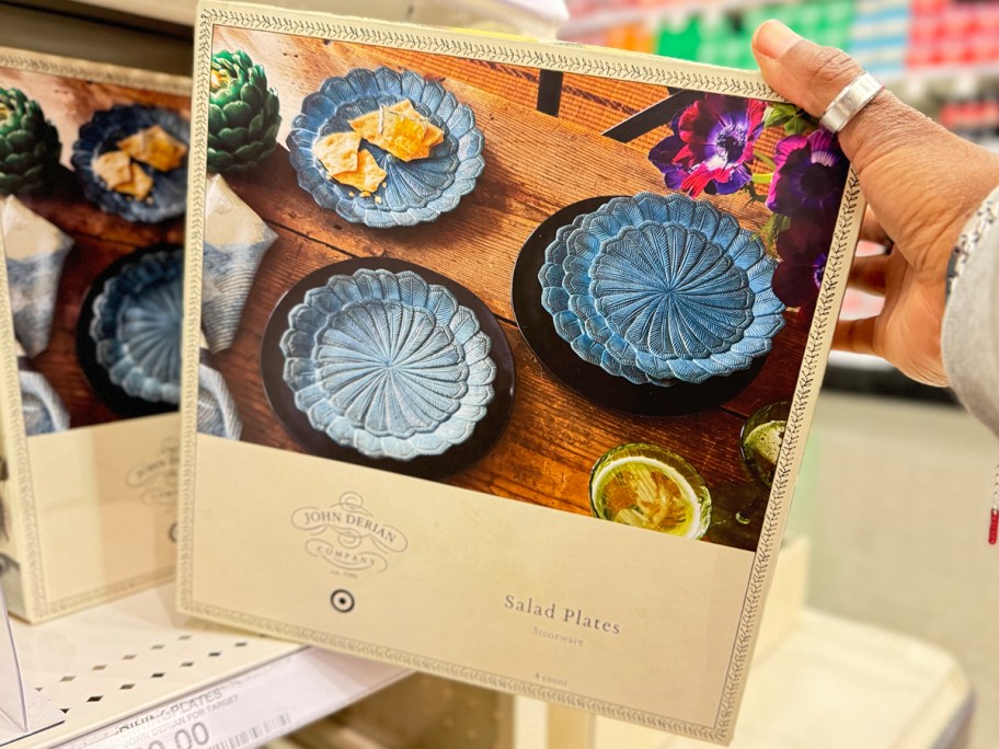 hand reaching for 4 pack of feather salad plates 