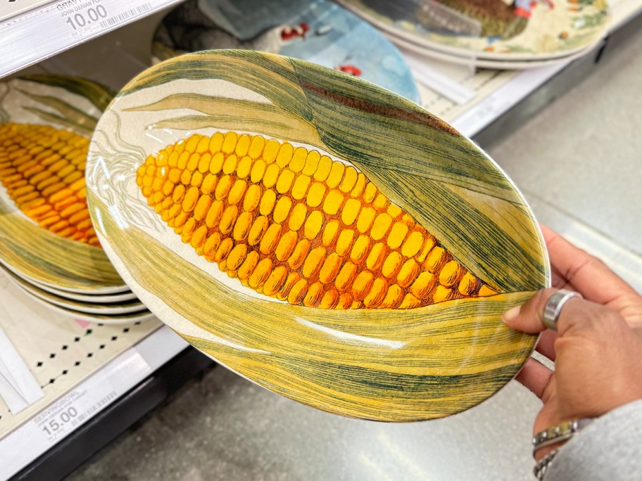 hand holding corn plate