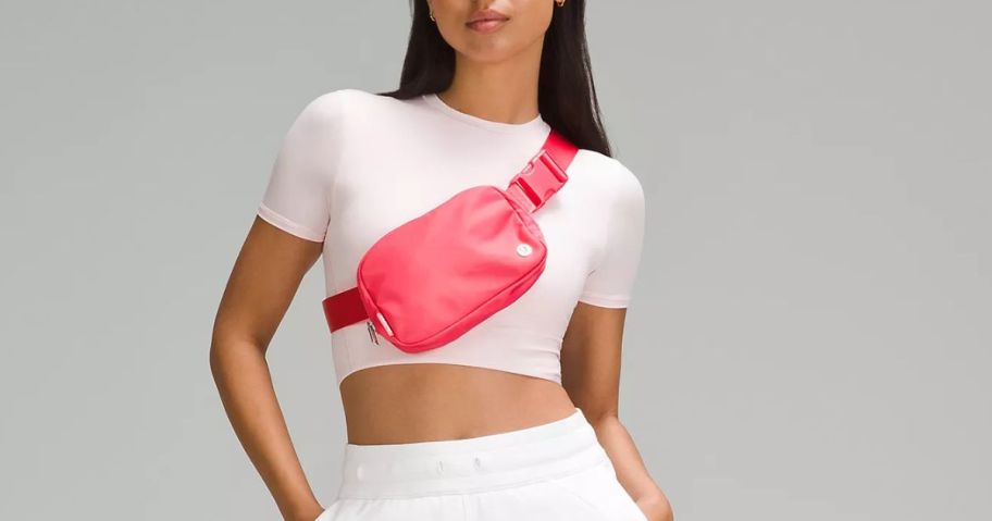 A woman wearing a lululemon Everywhere Belt Bag 1L in pink