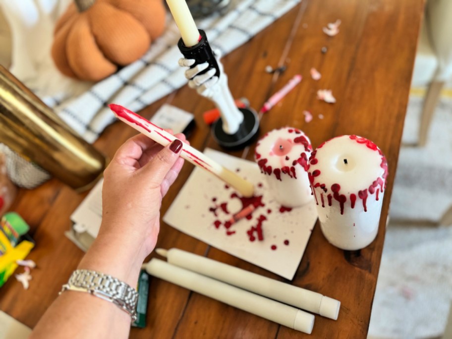 melting red crayon onto white candles for Halloween