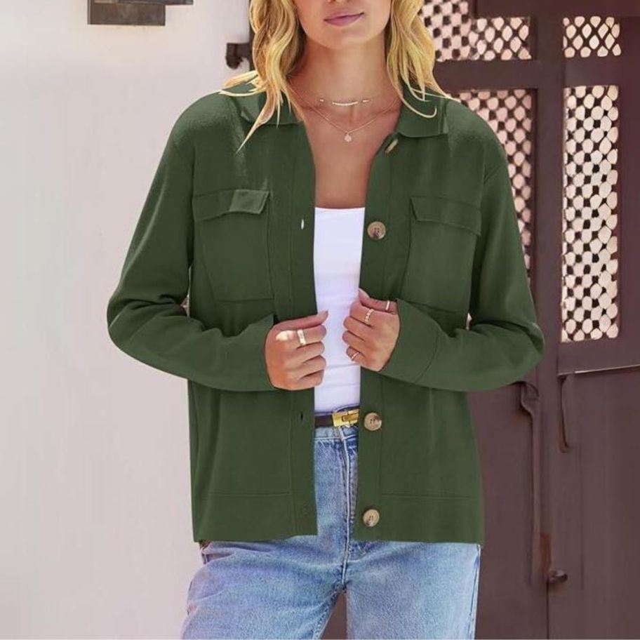 a woman wearing a green shacket cardigan with pockets