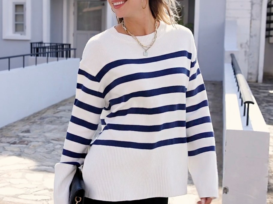 woman wearing white and blue striped oversized sweater 