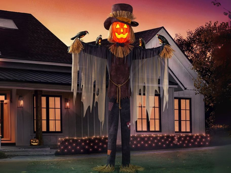 pumpkin head scarecrow in yard