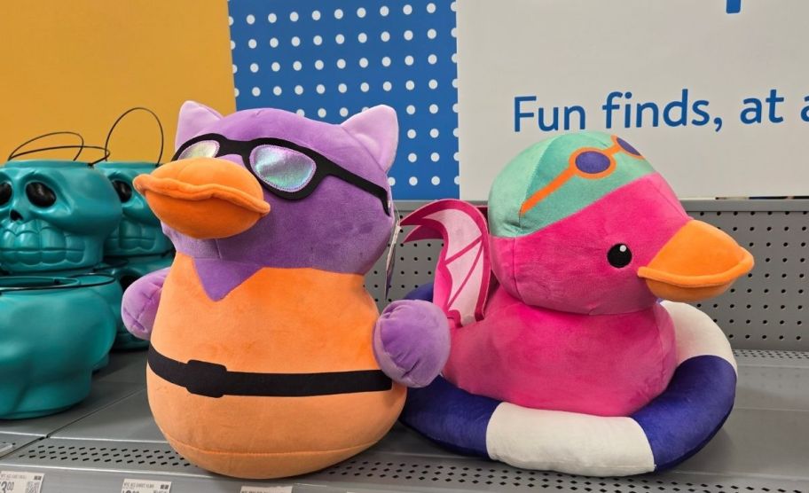 two plush duckies on a store shelf