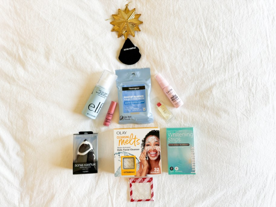 contents of the target beauty advent calendar displayed in the shape of a christmas tree on a white background