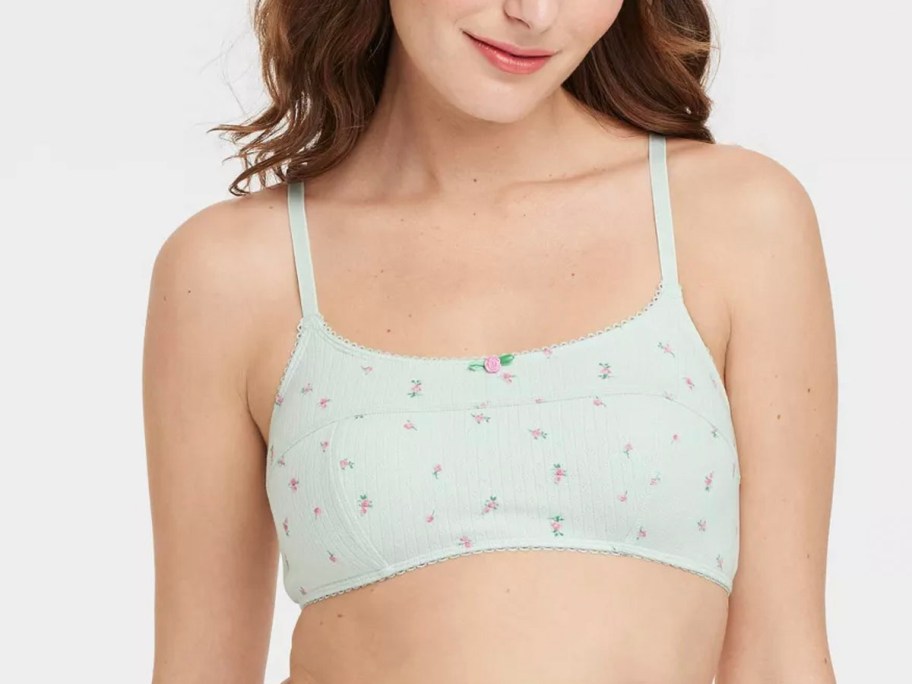 girl wearing green floral bralette 