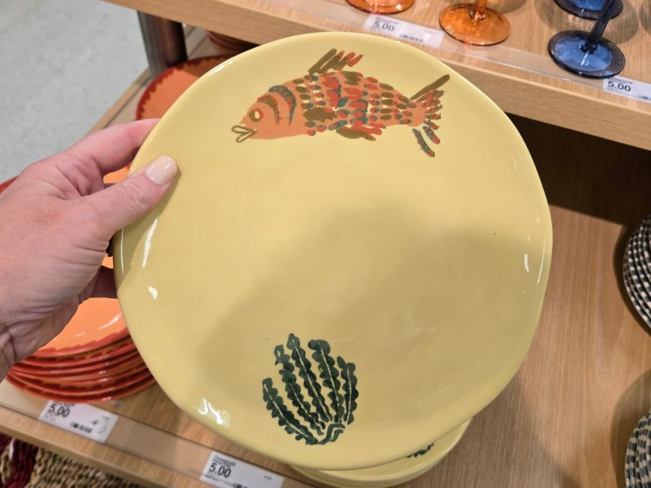 Threshold 9" Stoneware Dinner Plate with a fish on it in hand in store