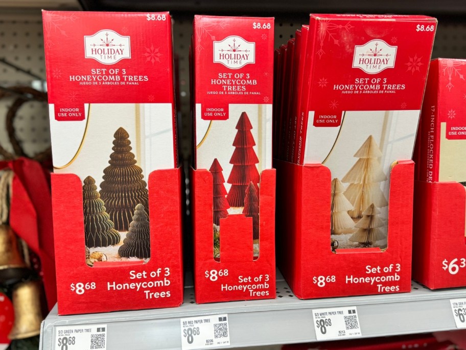 tabletop size paper holiday trees in various colors in boxes on a store shelf