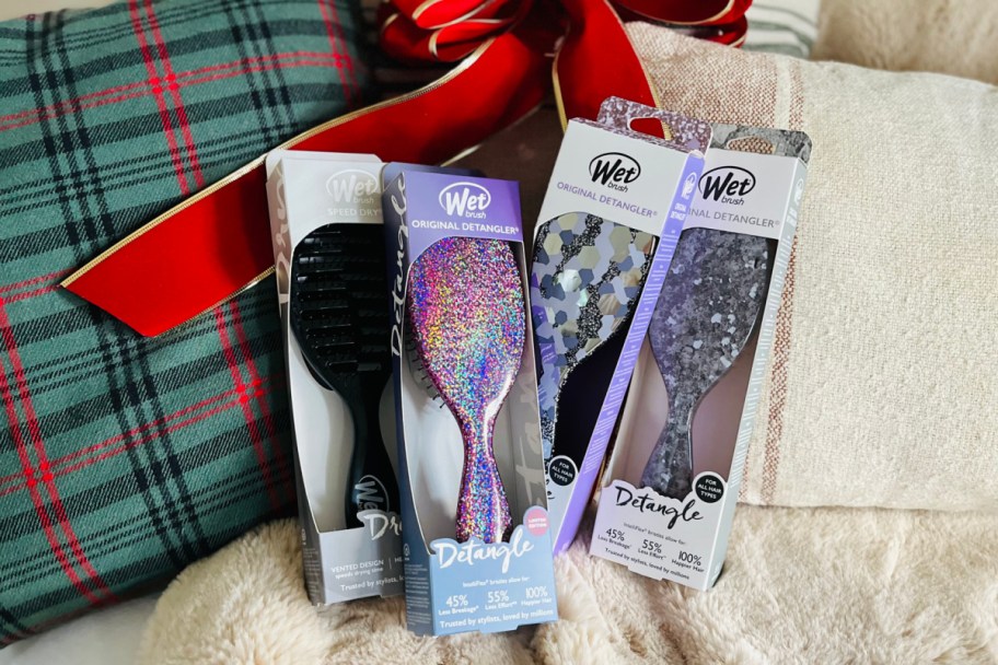 purple and black wet brushes next to red bow