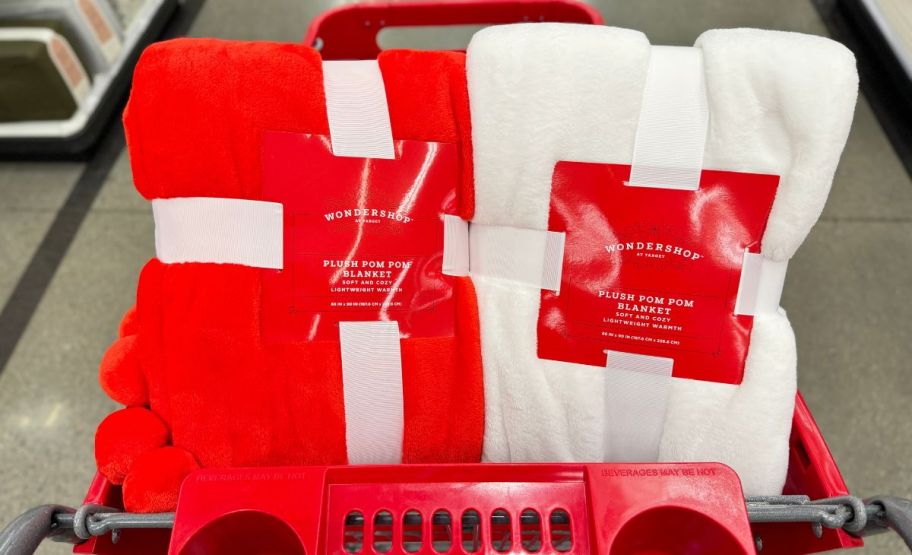 wondershop pom pom blankets in a red cart