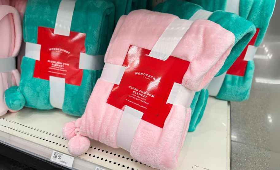 wondershop pom pom blankets on a store shelf