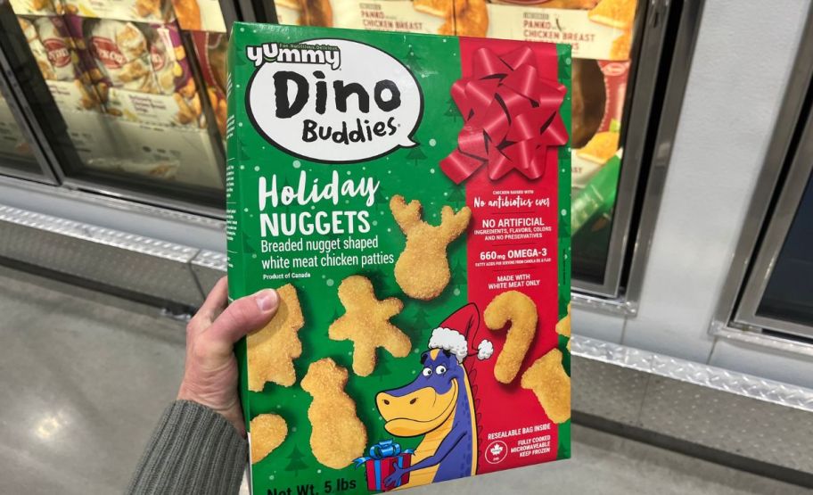 woman's hand holding a box of yummy dino buddies holiday shaped nuggets