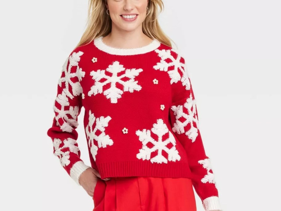 woman wearing a red sweater with white snowflakes