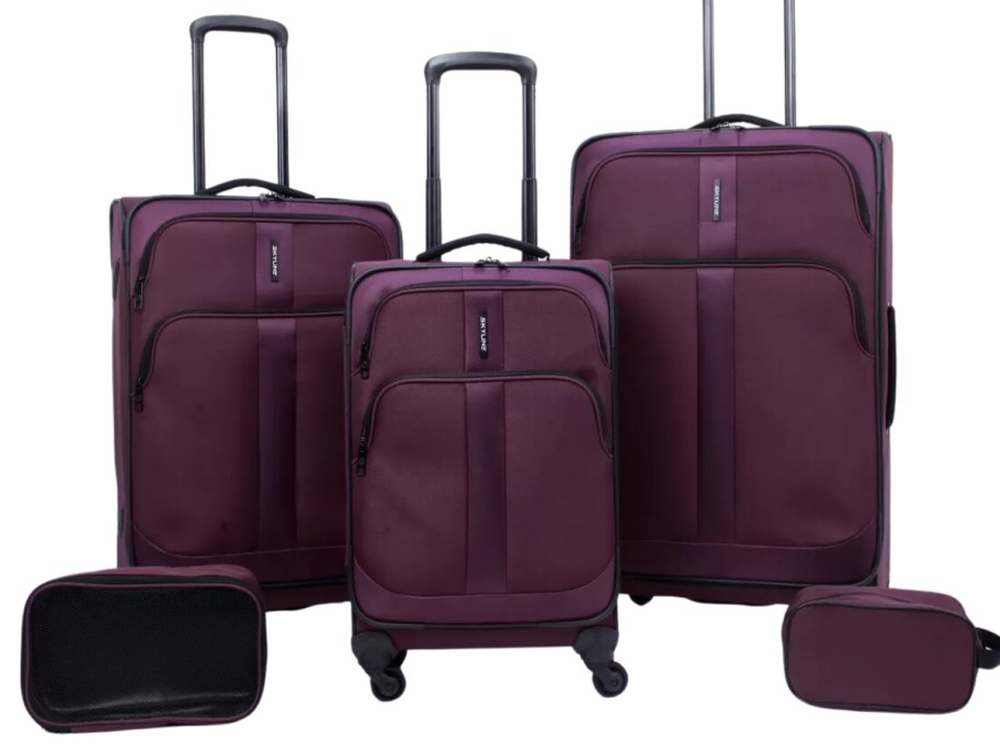 a 5 piece set of purple luggage with 3 wheeled suitcases and 2 small bags