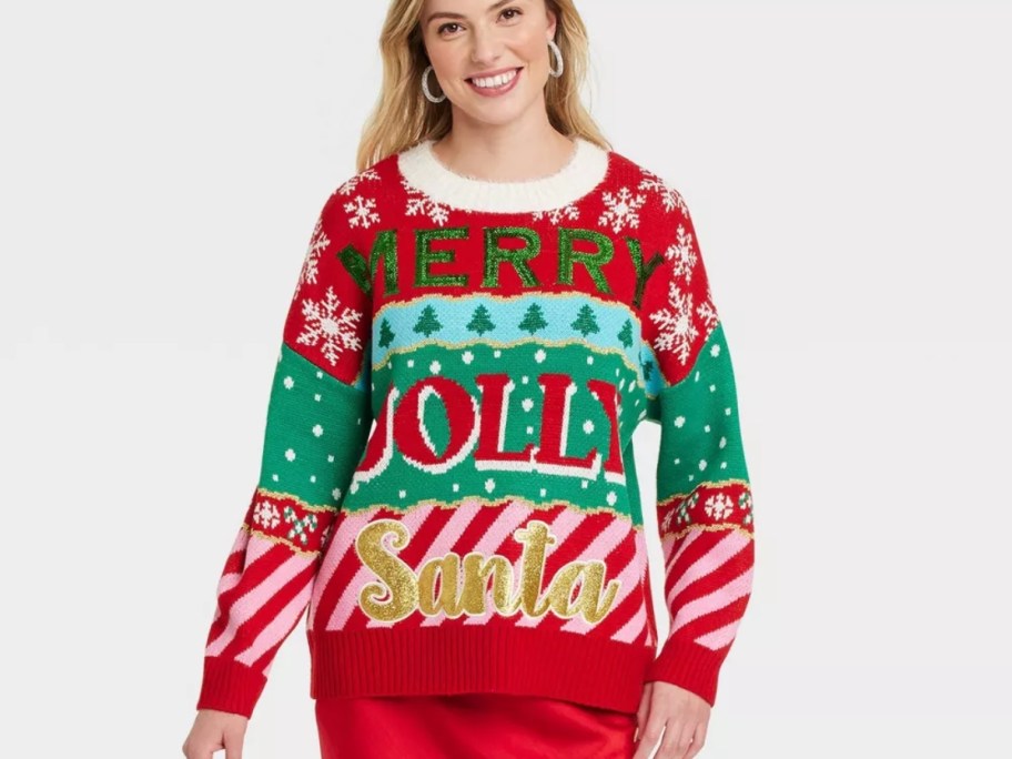 woman wearing a red and green Christmas sweater that says "Merry, Jolly, Santa"