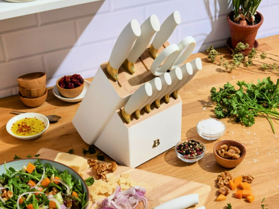 white Beautiful by Drew Barrymore Knife Set surrounded by food on a counter