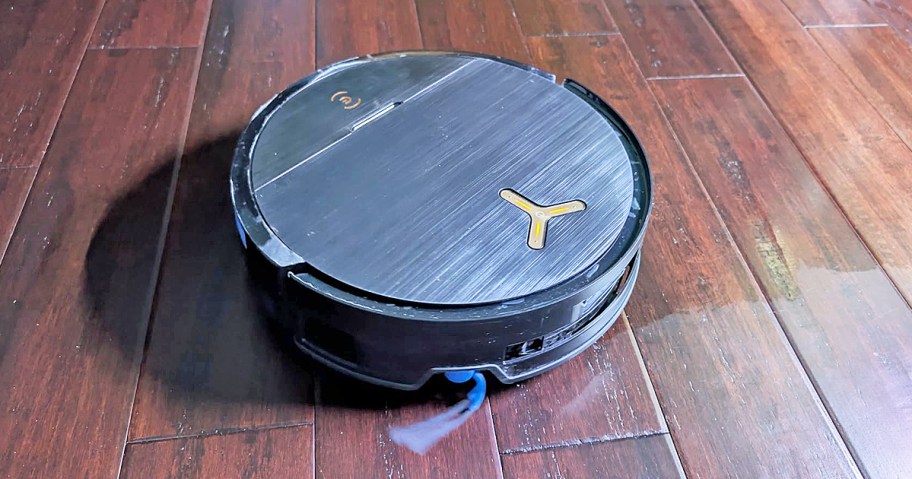 black robot vacuum cleaning hardwood floors
