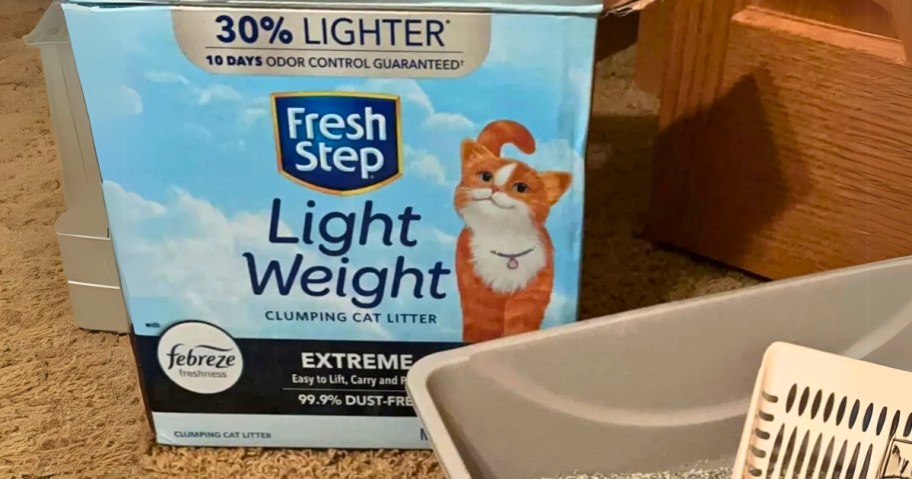 A box of Fresh Step Light Weight Cat Litter w/ Febreze 15.4lb
