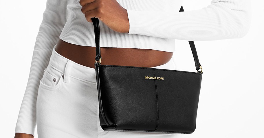 woman in a white outfit with a black crossbody bag