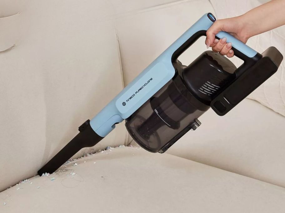 Tineco GO Pet Cordless Stick Vacuum w/ ZeroTangle Brush Technology attachment being used on the couch