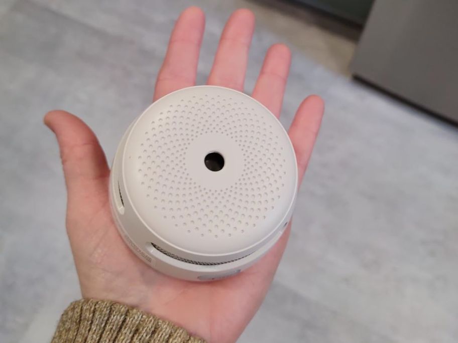 X-Sense Smoke Detector in the palm of a hand