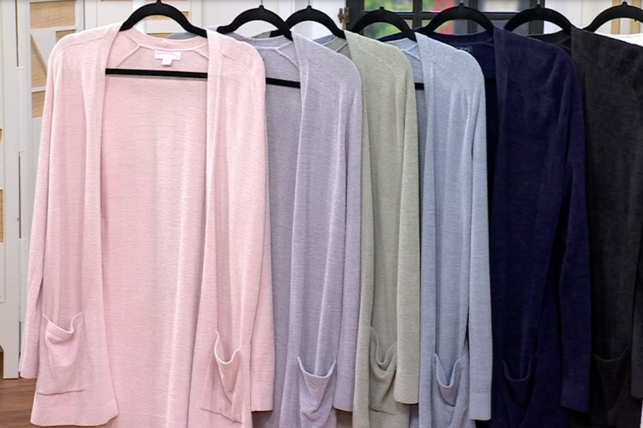 pink pirple green blue cardigans on hangers