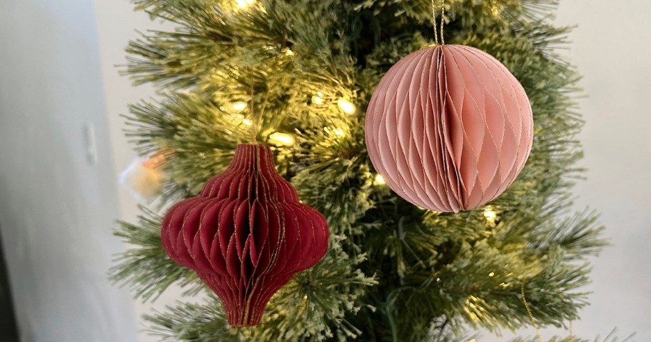 red and pink paper ornaments hanging on tree