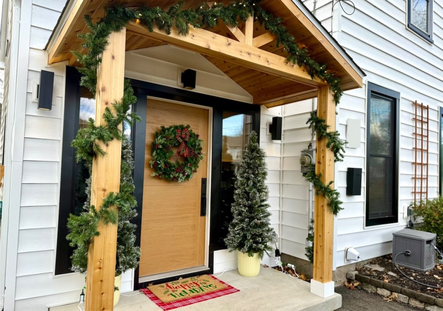 front door with outdoor christmas decorations