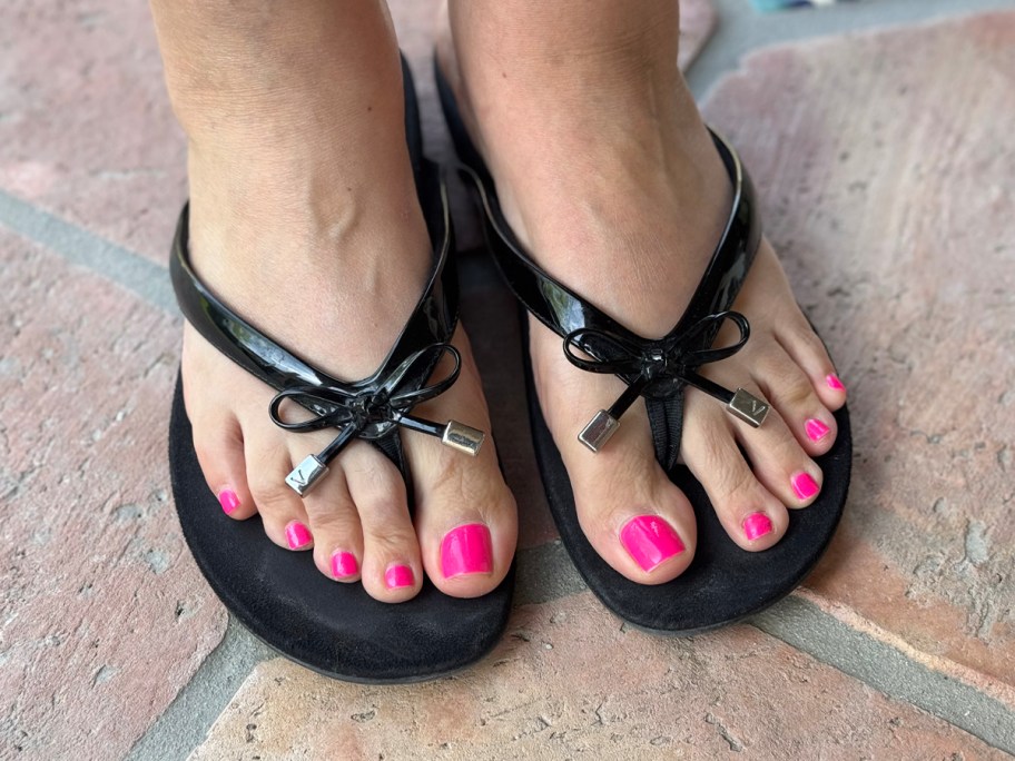 woman wearing black thong sandals