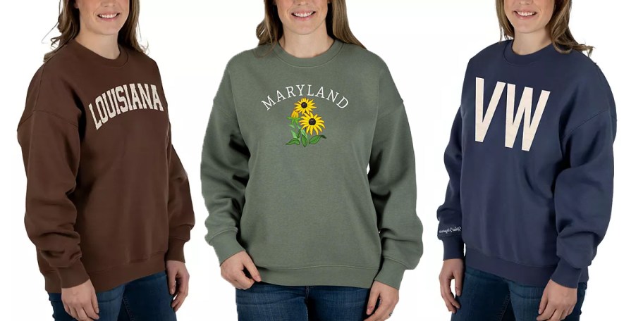 three women wearing brown, green, and blue state sweatshirts
