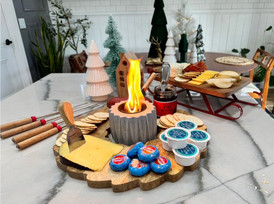 two holiday trays with mini brie s'more supplies