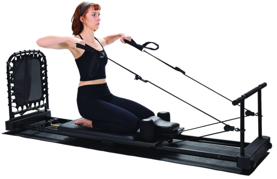woman using a Pilates machine to work out
