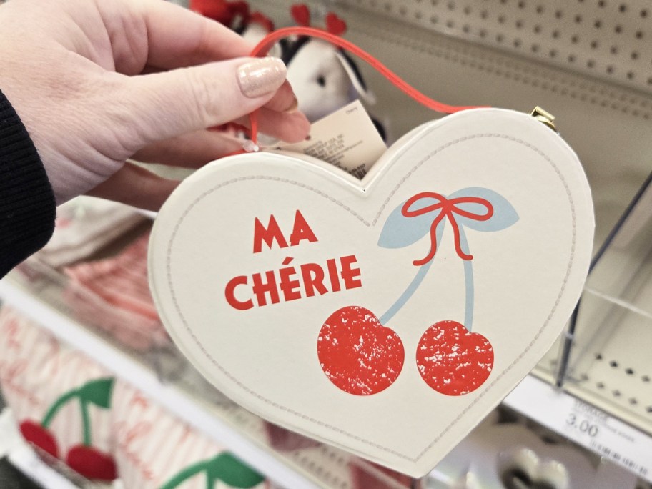 hand holding up a cherry print heart shaped storage box