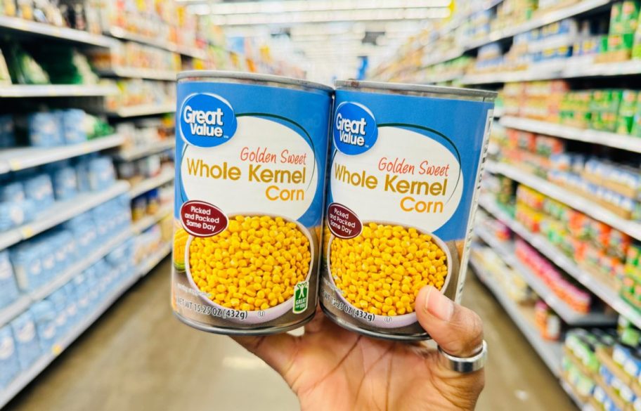 hand holding up 2 cans of corn, ingredients from the Walmart holiday meals