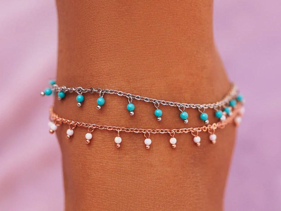 ankle with multiple beaded anklets