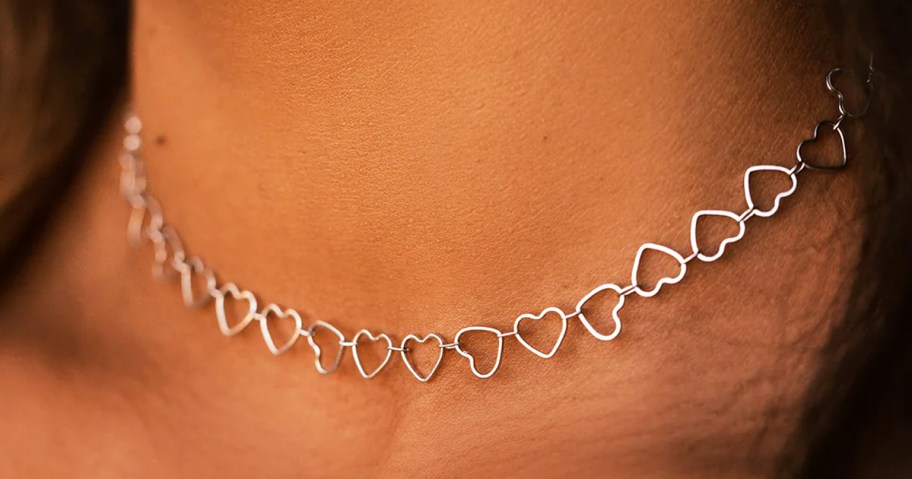 woman wearing silver mini hearts choker