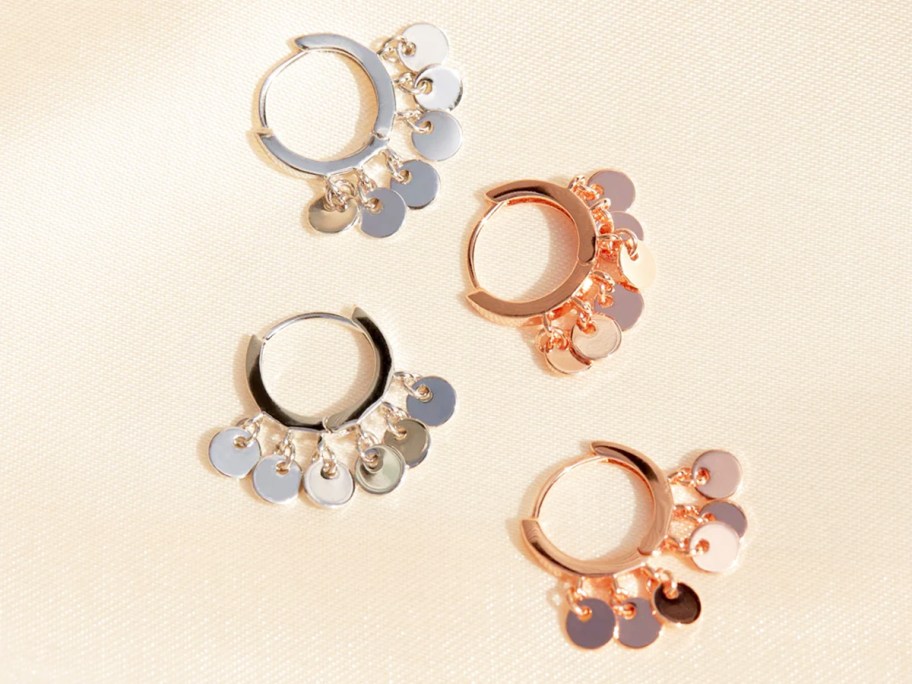 silver and rose gold pairs of huggie earrings