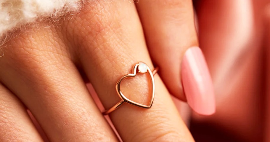 fingers with a wire heart ring
