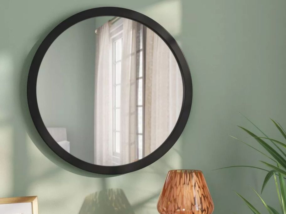 Room Essentials 20" Round Wall Mirror on wall in bedroom