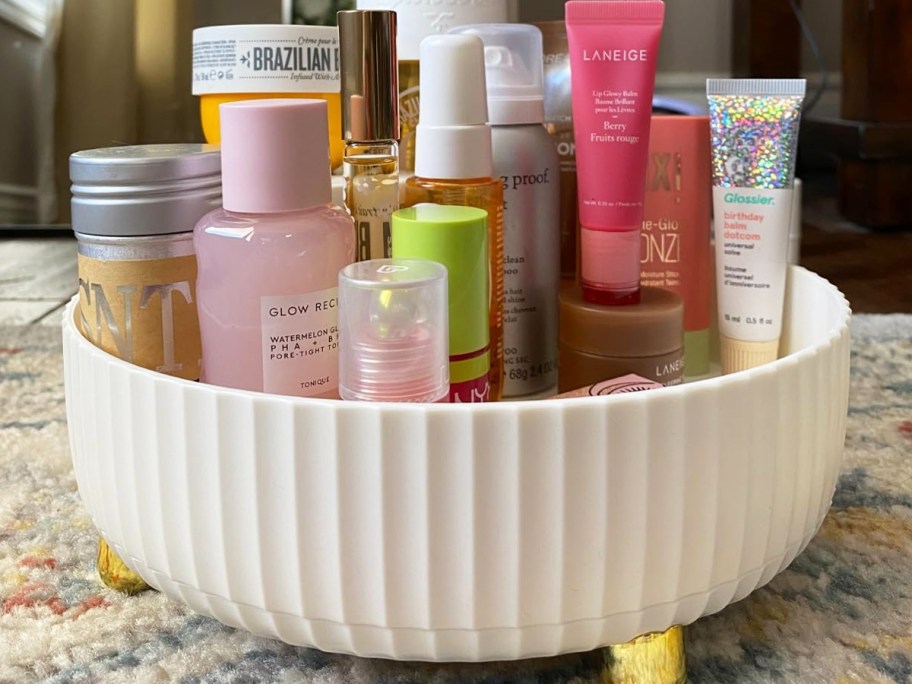 beauty products in a round white organizer on vanity