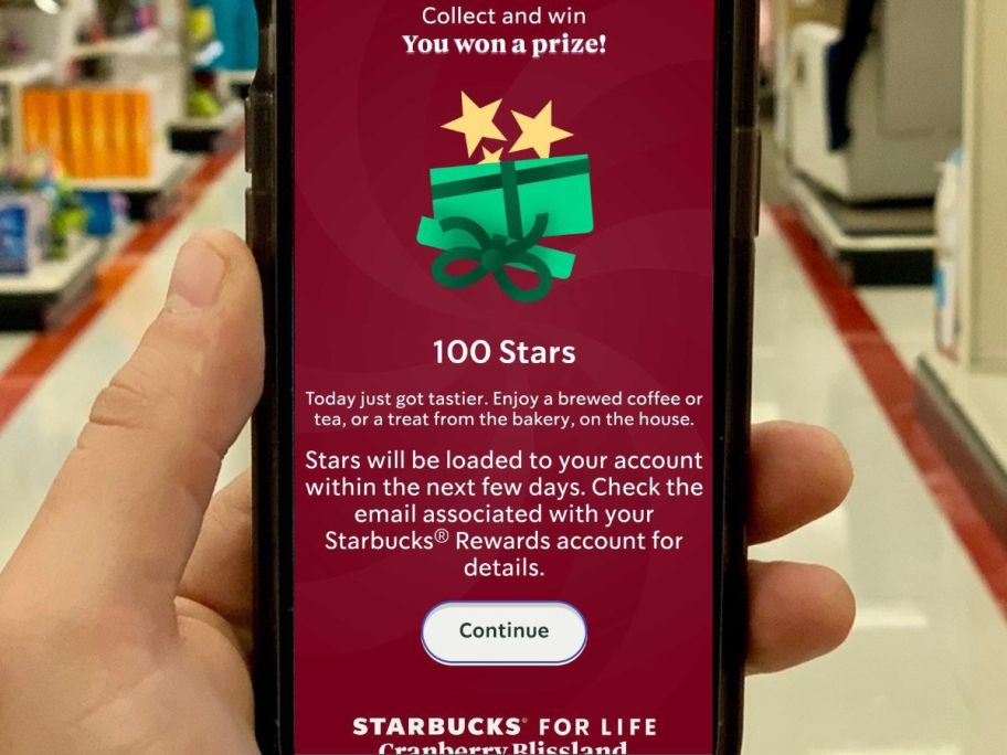 Phone with Starbucks for Life 100 Stars winning play on it