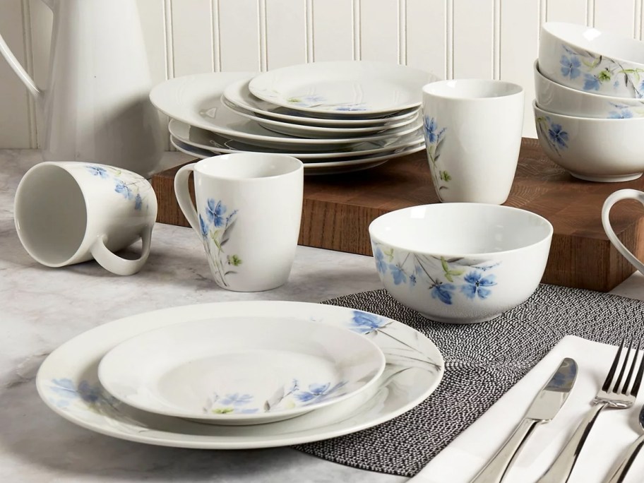 white and blue flower print dinnerware set on table