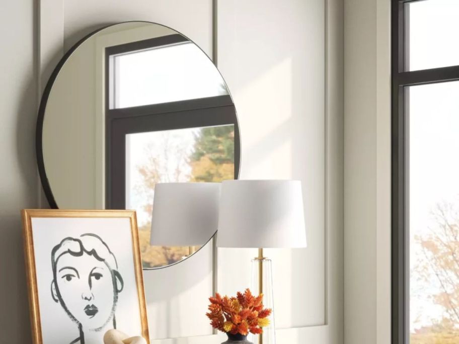 Threshold 28" Round Infinity Circle Mirror on wall in living room