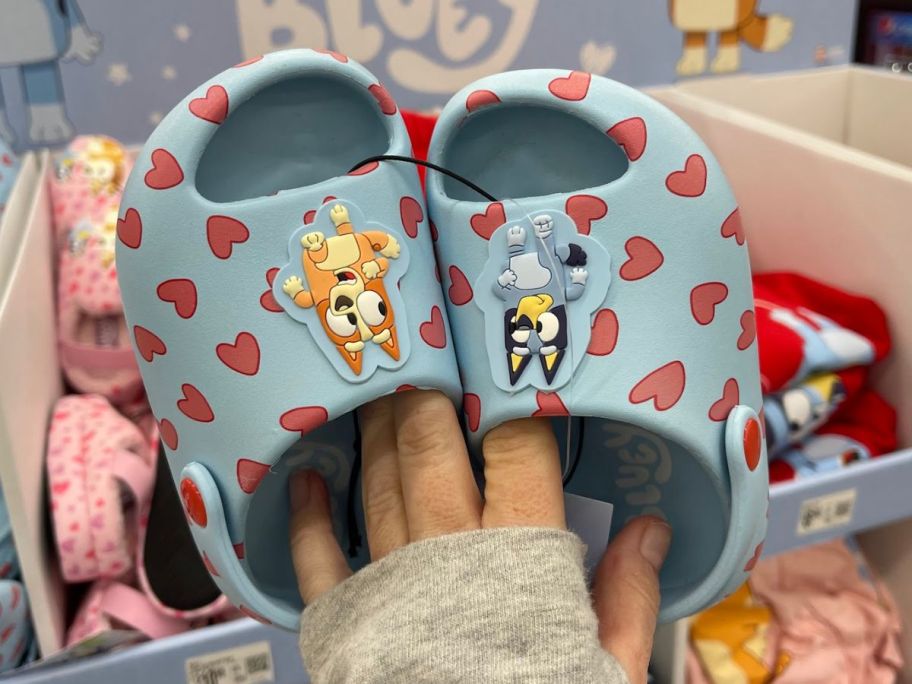 Hand holding a pair of Bluey Toddler Slides