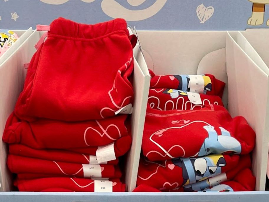A display holding Bluey Kids valentine's Day joggers and sweatshirts