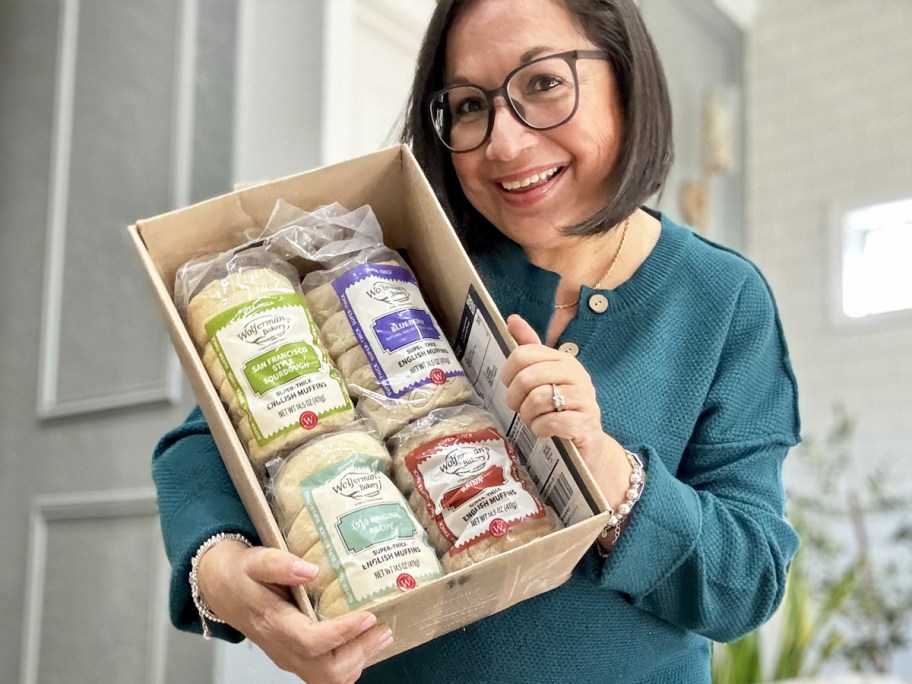 woman holding up a box of Wolferman's English Muffins